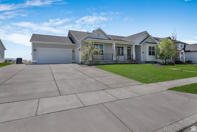 14 E 2300 S, Kaysville, UT 84037 - view of front of house featuring a porch, board and batten siding, an attached garage, concrete driveway, and a front yard
