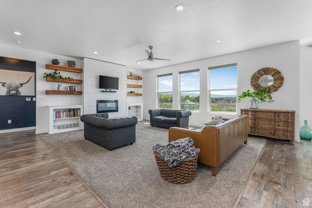 14 E 2300 S, Kaysville, UT 84037 - living room featuring wood finished floors, ceiling fan, recessed lighting, a fireplace, and baseboards
