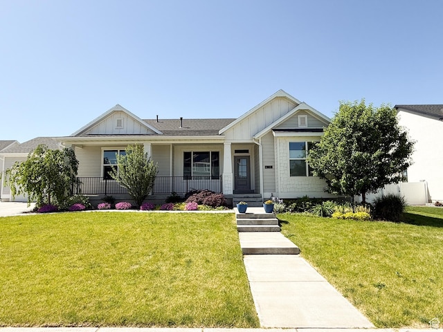 14 E 2300 S, Kaysville, UT 84037 - view of front of home featuring board and batten siding, covered porch, and a front yard