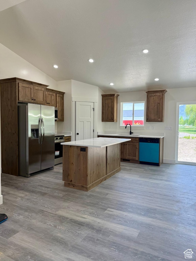 136 W Main St, Fielding, UT 84311 - kitchen with appliances with stainless steel finishes, light wood-style floors, a center island, light countertops, and recessed lighting