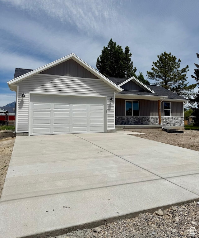 136 W Main St, Fielding, UT 84311 - single story home with a garage, driveway, stone siding, and board and batten siding