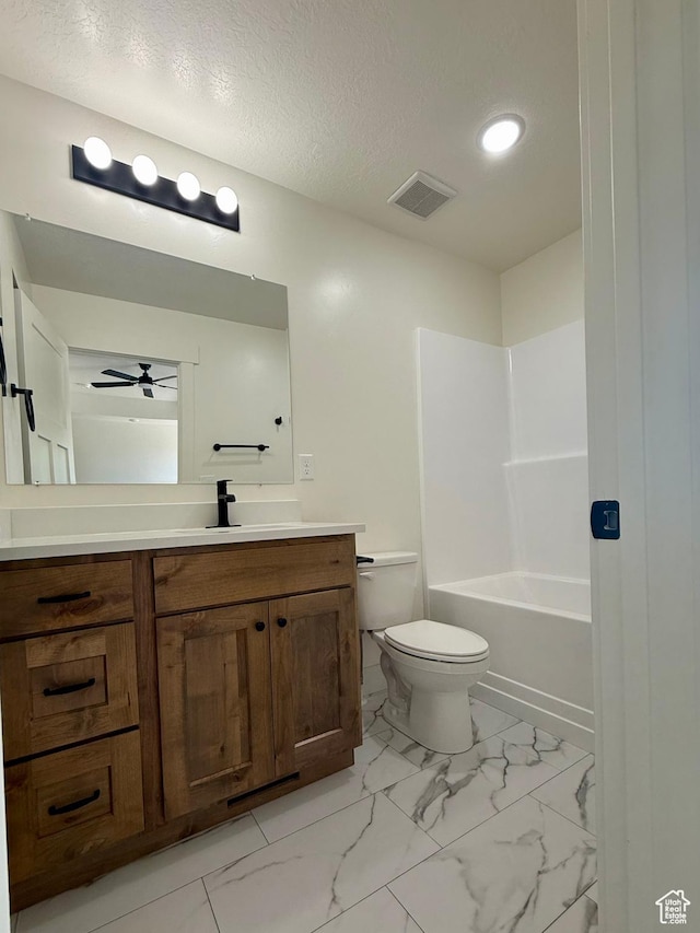 136 W Main St, Fielding, UT 84311 - bathroom featuring vanity, a ceiling fan, toilet, marble finish floors, and shower / bathtub combination