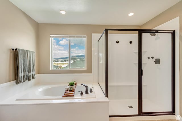 full bathroom featuring a shower stall, a garden tub, and recessed lighting
