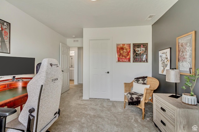 office area with visible vents and light colored carpet