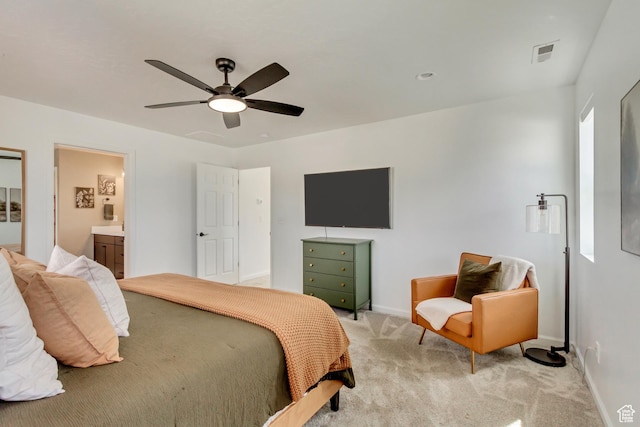bedroom featuring a ceiling fan, ensuite bathroom, light carpet, baseboards, and visible vents