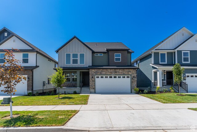 3677 W 950 N Unit 219, Lehi, UT 84043 - craftsman-style house with board and batten siding, an attached garage, driveway, and a front lawn