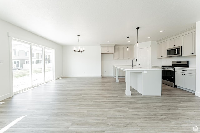 3677 W 950 N Unit 219, Lehi, UT 84043 - kitchen featuring appliances with stainless steel finishes, a chandelier, recessed lighting, light wood-style flooring, and an island with sink