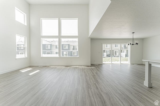 3677 W 950 N Unit 219, Lehi, UT 84043 - unfurnished living room with a chandelier and light wood-type flooring