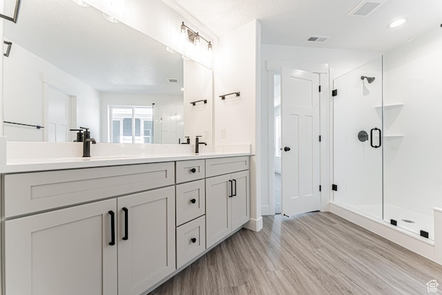 3677 W 950 N Unit 219, Lehi, UT 84043 - full bathroom featuring wood finished floors, double vanity, and a shower stall