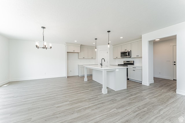 3677 W 950 N Unit 219, Lehi, UT 84043 - kitchen with stainless steel appliances, a chandelier, recessed lighting, light wood-type flooring, and a kitchen breakfast bar