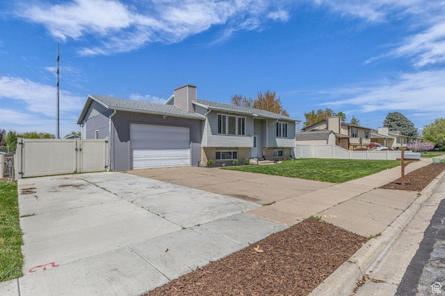 1282 S 875 W, Woods Cross, UT 84087 - view of front of house featuring a chimney, a gate, fence, driveway, and a garage
