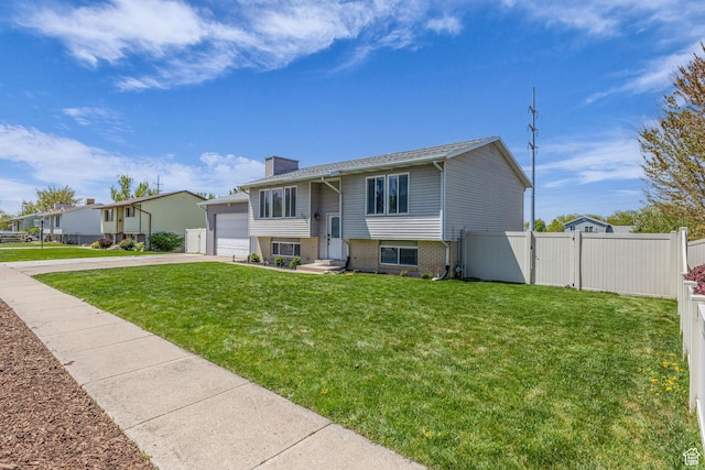 1282 S 875 W, Woods Cross, UT 84087 - raised ranch featuring a chimney, concrete driveway, fence, a garage, and a front yard