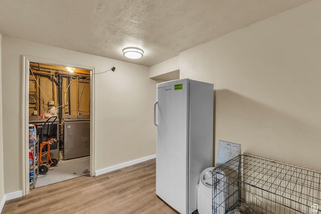 1282 S 875 W, Woods Cross, UT 84087 - interior space featuring washer / dryer, wood finished floors, a textured ceiling, and baseboards