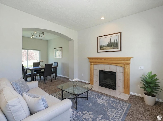 12261 S Stephens View Cir, Draper, UT 84020 - carpeted living room with arched walkways, a fireplace, and recessed lighting
