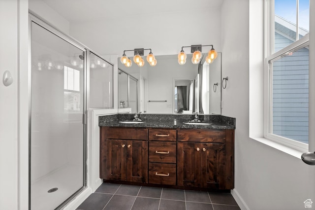 full bath with tile patterned flooring, a sink, a shower stall, and double vanity
