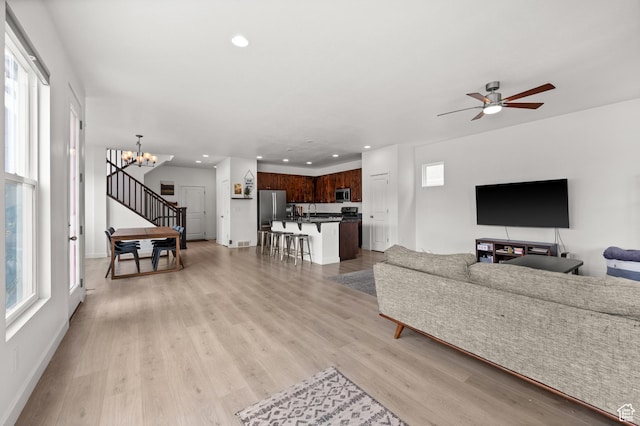 living room with plenty of natural light, recessed lighting, and light wood-style floors