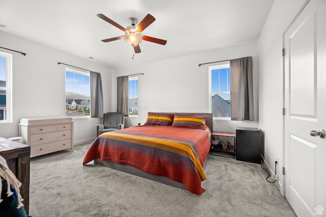 bedroom featuring a ceiling fan, baseboards, and carpet floors