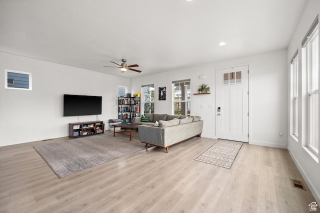 living area with wood finished floors, ceiling fan, baseboards, visible vents, and recessed lighting