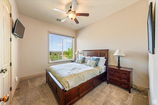 188 N 6680 W Unit 4, Hurricane, UT 84737 - bedroom with light carpet, a textured ceiling, baseboards, visible vents, and a ceiling fan