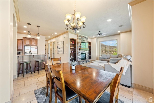 188 N 6680 W Unit 4, Hurricane, UT 84737 - dining area featuring ornamental molding, a textured ceiling, visible vents, and a fireplace