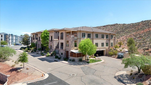 188 N 6680 W Unit 4, Hurricane, UT 84737 - view of building exterior with an attached garage, cooling unit, and a mountain view