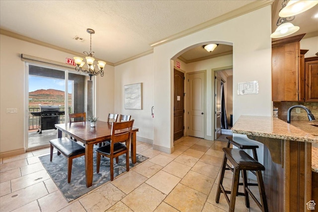 188 N 6680 W Unit 4, Hurricane, UT 84737 - dining room with crown molding, arched walkways, an inviting chandelier, baseboards, and visible vents