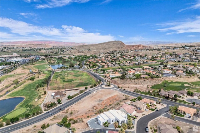 birds eye view of property with a water and mountain view, view of golf course, and a residential view
