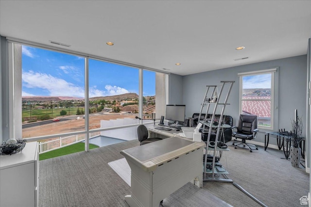 office featuring visible vents, expansive windows, carpet flooring, and recessed lighting