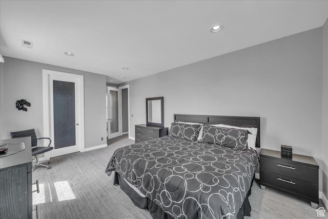 carpeted bedroom featuring baseboards, visible vents, and recessed lighting