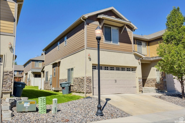 view of front facade with stucco siding, stone siding, concrete driveway, and a garage