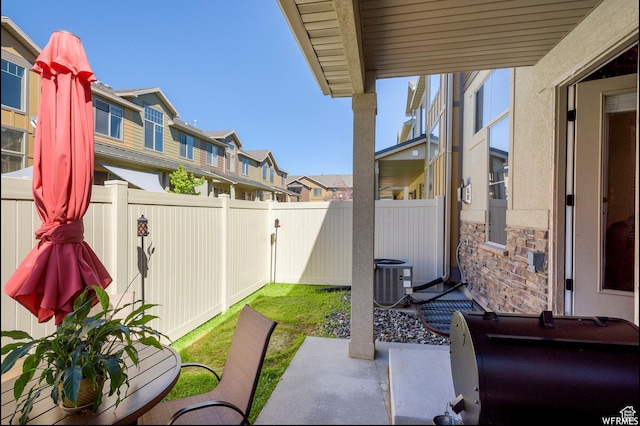 view of patio with fence, a residential view, and cooling unit