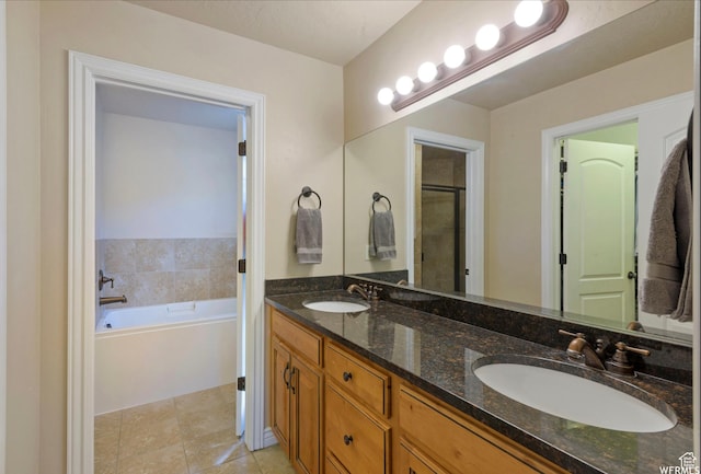 full bathroom with tile patterned floors, a garden tub, a sink, and double vanity