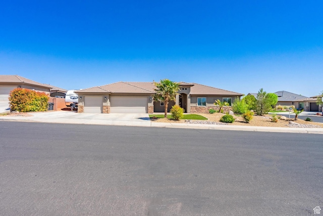 view of front of property with a tile roof, driveway, stone siding, a garage, and stucco siding