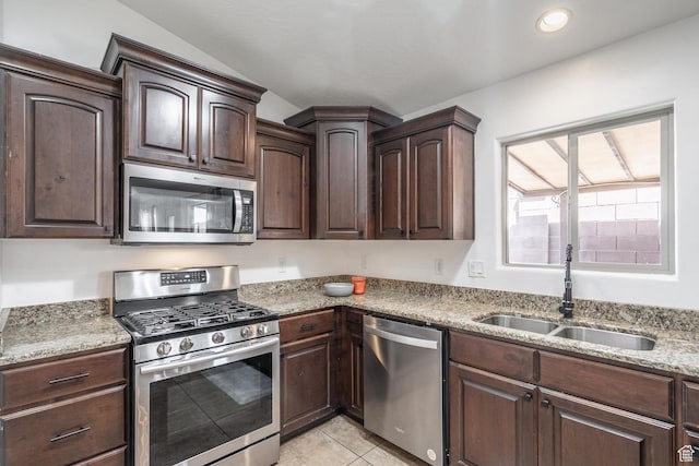 1024 Painted Cloud Pl, Washington, UT 84780 - kitchen featuring stainless steel appliances, a sink, light tile patterned flooring, light stone countertops, and dark brown cabinetry