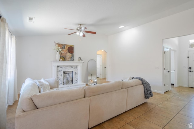 1024 Painted Cloud Pl, Washington, UT 84780 - living area with a fireplace with raised hearth, light tile patterned floors, ceiling fan, arched walkways, and visible vents