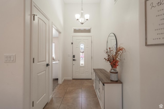 1024 Painted Cloud Pl, Washington, UT 84780 - entryway featuring baseboards, a towering ceiling, a chandelier, and light tile patterned floors