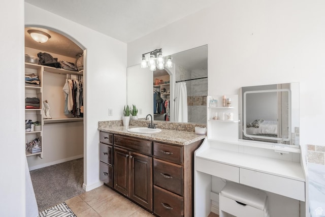 1024 Painted Cloud Pl, Washington, UT 84780 - bathroom featuring a spacious closet, tile patterned flooring, and vanity