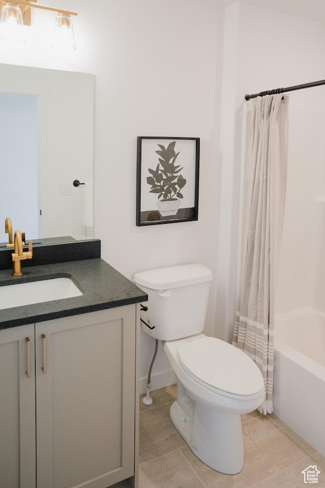 bathroom featuring shower / tub combo with curtain, vanity, tile patterned flooring, and toilet