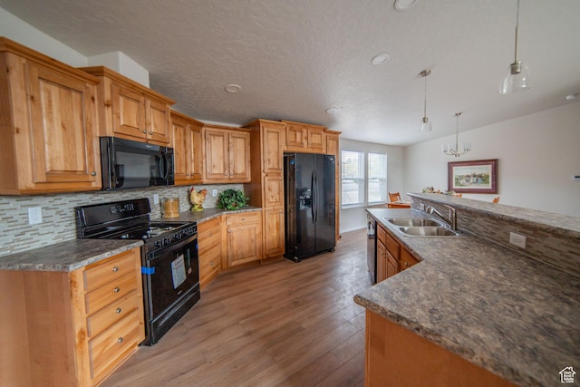163 Eagle St, Eureka, UT 84628 - kitchen featuring light wood-style floors, decorative backsplash, a sink, and black appliances