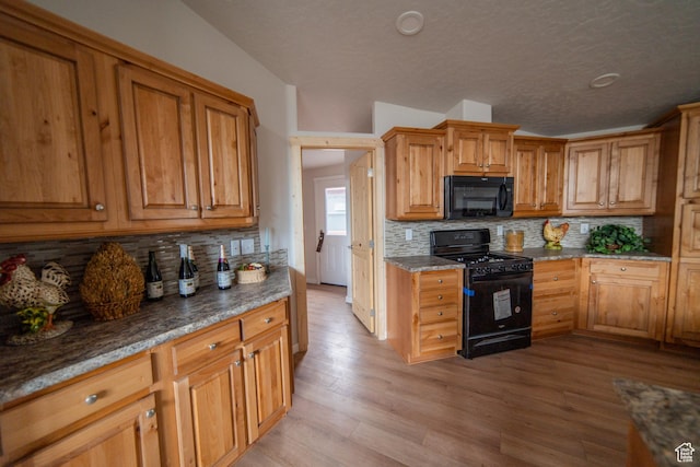 163 Eagle St, Eureka, UT 84628 - kitchen featuring light wood finished floors, brown cabinets, backsplash, and black appliances