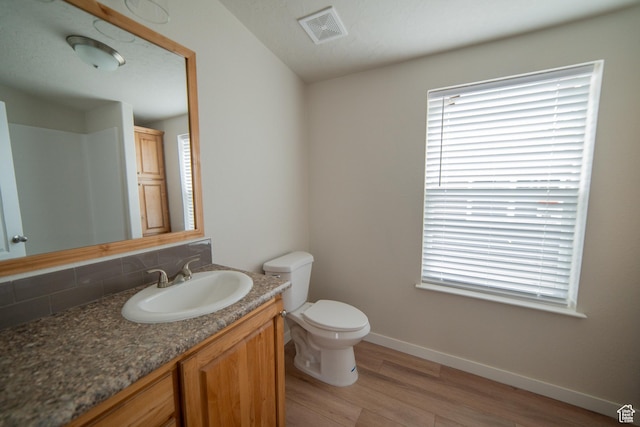163 Eagle St, Eureka, UT 84628 - bathroom featuring wood finished floors, visible vents, a wealth of natural light, baseboards, and tasteful backsplash