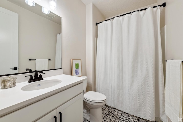 bathroom featuring tile patterned flooring, vanity, curtained shower, and toilet