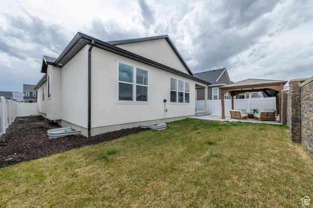 back of house with a yard, a fenced backyard, a gazebo, an outdoor hangout area, and a patio