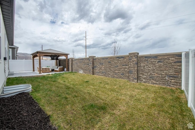 view of yard featuring a fenced backyard, a gazebo, a patio area, and an outdoor hangout area