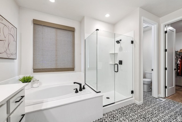 full bath with toilet, a stall shower, recessed lighting, a garden tub, and vanity