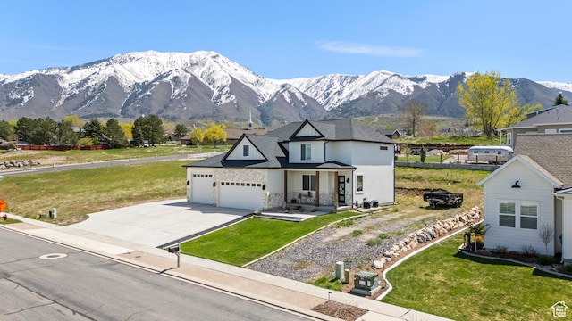 285 W Olympic Ln, Elk Ridge, UT 84651 - view of front of house featuring an attached garage, a mountain view, a front yard, and driveway