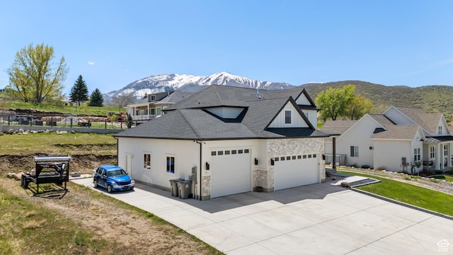 285 W Olympic Ln, Elk Ridge, UT 84651 - view of home's exterior featuring a mountain view, stone siding, concrete driveway, a garage, and a shingled roof