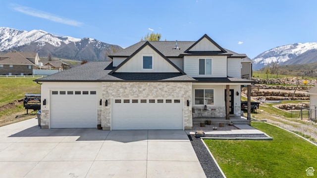 285 W Olympic Ln, Elk Ridge, UT 84651 - view of front of property featuring a mountain view, driveway, stone siding, a garage, and board and batten siding