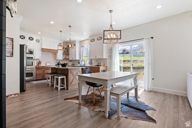 285 W Olympic Ln, Elk Ridge, UT 84651 - dining room featuring recessed lighting, baseboards, light wood-style floors, and a chandelier