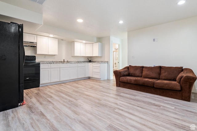 285 W Olympic Ln, Elk Ridge, UT 84651 - kitchen featuring black appliances, open floor plan, light wood-style floors, white cabinets, and under cabinet range hood